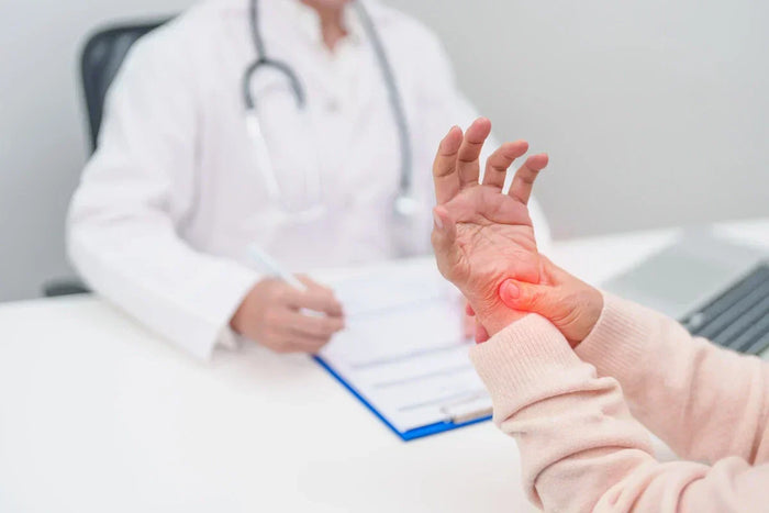 woman holding her wrist at the doctor's