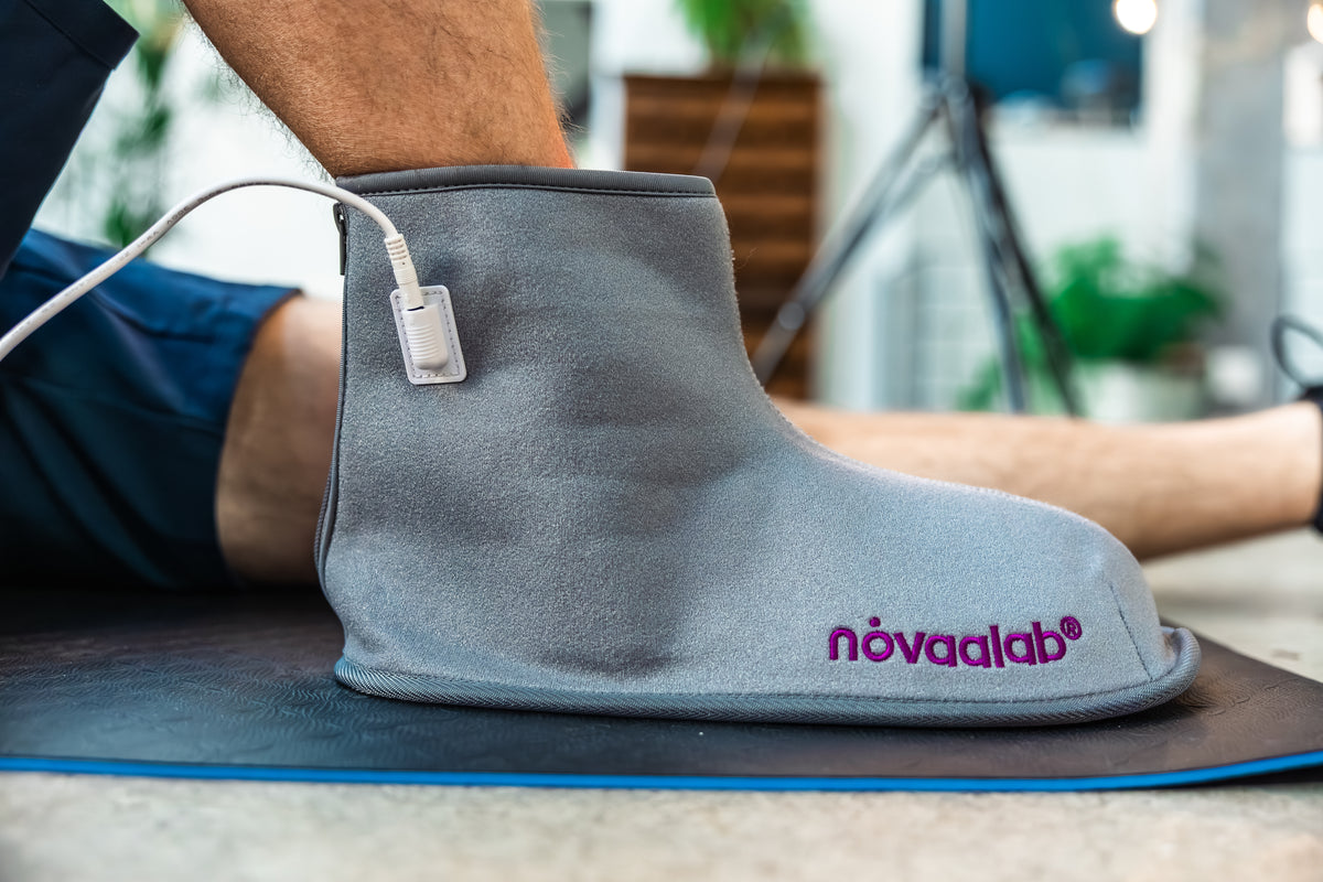 Racer treating their ankle with the Novaa Light Boot after a race, before the swelling has even gone down