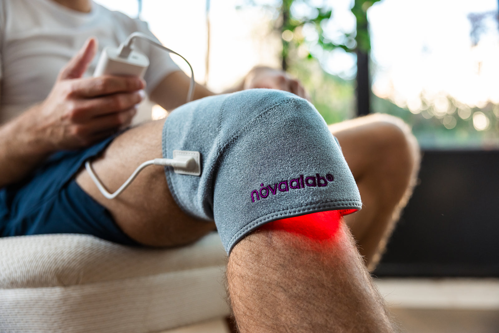Athlete treating a sore knee with the Novaa Knee Ultra right after a WOD
